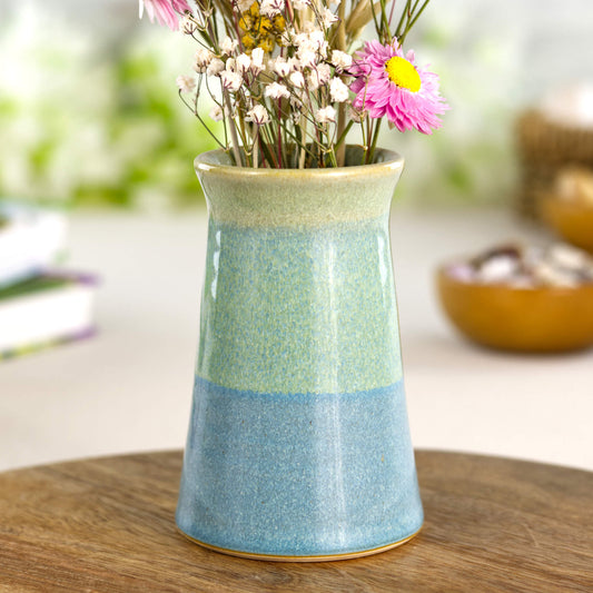 Two-tone ceramic bud vase in sea-glass blue and soft sage green, a wheel-thrown studio pottery piece with a gently flared rim and tranquil coastal-inspired colours.