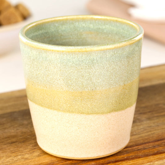 Handmade banded espresso cup close-up showing soft green Sea Smoothed Pebble glaze and matte base