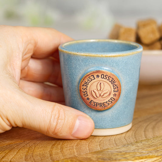 Wheel-thrown stoneware espresso cup held in hand showing size and barista espresso scale
