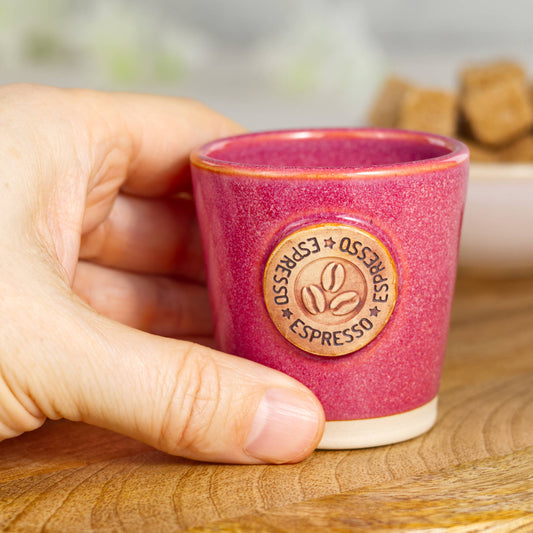 Wheel-thrown stoneware espresso cup in hand showing small coffee size and solid feel