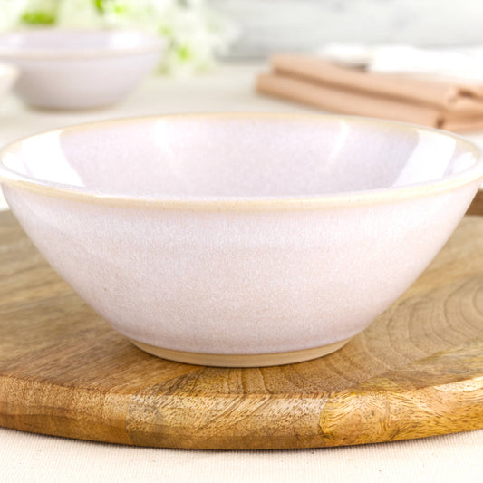 Close-up of a wheel-thrown white stoneware bowl with a glossy speckled glaze, soft minimalist finish and simple Scandi-style ceramic texture