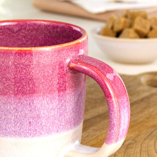 Close-up of the handle and layered Crimson and White glaze on a handmade ceramic mug from my British pottery studio