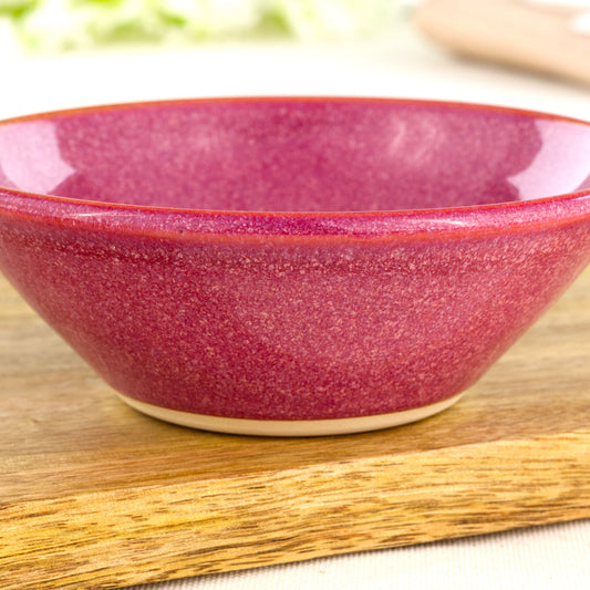 Close-up of rich Crimson Sea Smoothed Pebble glaze on a wheel-thrown stoneware bowl with glossy speckled finish