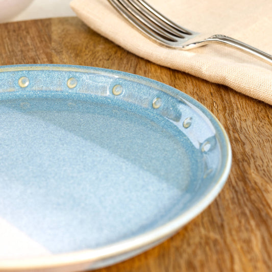 Close-up of a Coastal Blue and White ceramic small plate, highlighting the glossy speckled glaze and hand-finished dotted rim detail
