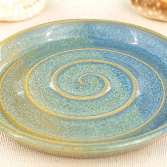 Close view of Coastal Blue and Pale Green glaze, spiral ridges with flowing two tone finish and speckled surface detail