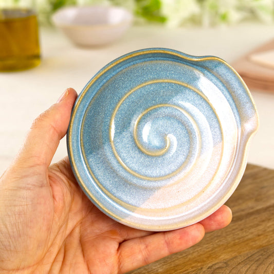 Coastal Blue and White pottery spoon rest shown in hand, compact handmade utensil holder for cooker side use