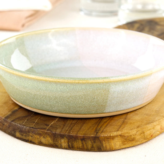 Close-up of a handmade stoneware tapas bowl in Pale Green & White, highlighting the glossy speckled glaze, soft layered colour and shallow shape for serving olives, dips and antipasti