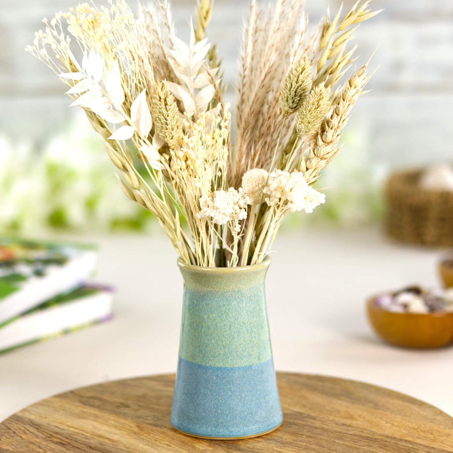 Artisan pastel ceramic bud vase in serene blue and soft green tones, a two-tone handcrafted stoneware vessel ideal for dried grasses and understated home décor.