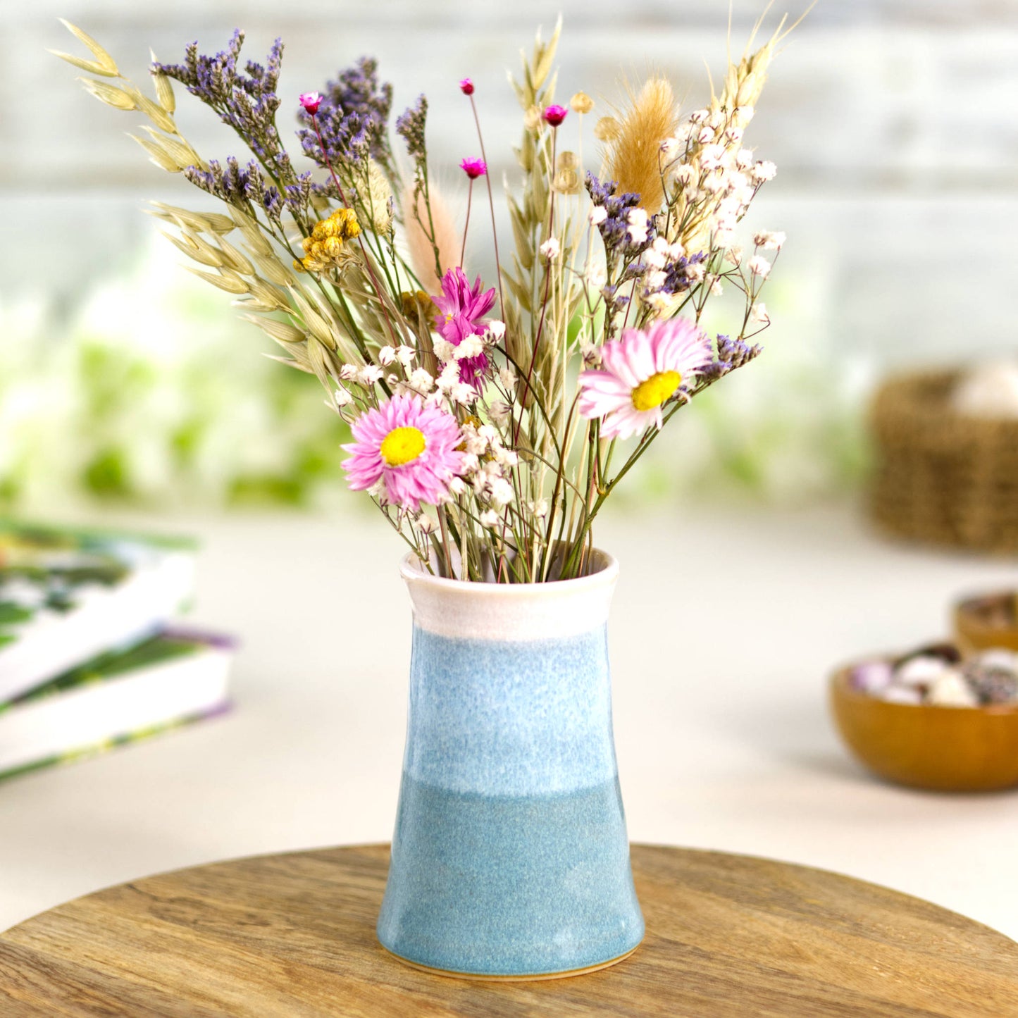 Coastal Blue and white handmade stoneware bud vase with a bouquet of colourful dried flowers, perfect for cottagecore and modern rustic home styling.
