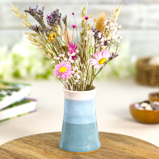 Coastal Blue and white handmade stoneware bud vase with a bouquet of colourful dried flowers, perfect for cottagecore and modern rustic home styling.