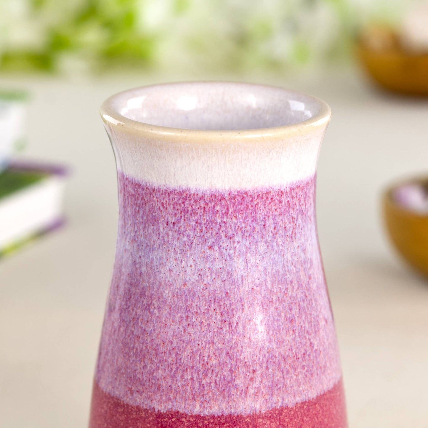 Wheel-thrown stoneware bud vase with a textured glaze flow in deep crimson and soft white, showcasing a white-rimmed neck, pastel tonal transitions, and a gently tapered silhouette.