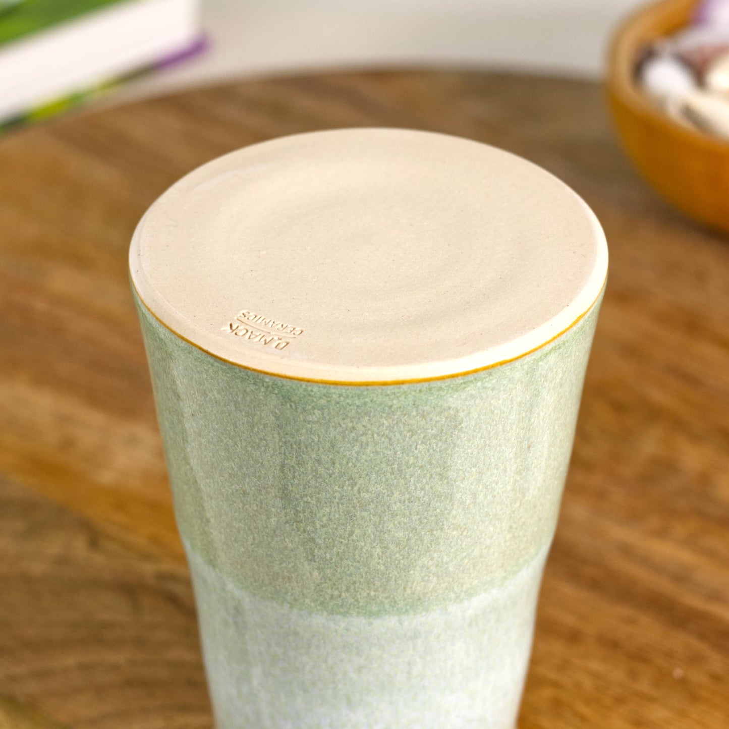 Burnished smooth base of a handmade conical stoneware bud vase in Pale Green and white, hand-thrown British studio pottery with maker’s mark.