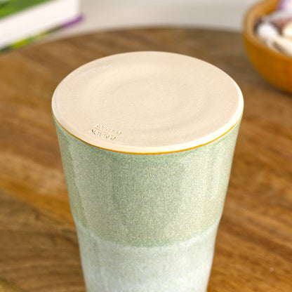 Burnished smooth base of a handmade conical stoneware bud vase in Pale Green and white, hand-thrown British studio pottery with maker’s mark.