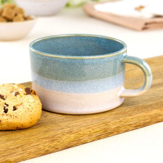 Handmade Coastal Blue and White cappuccino cup in layered glaze finish on oak board with cookie, wheel-thrown stoneware flat white cup