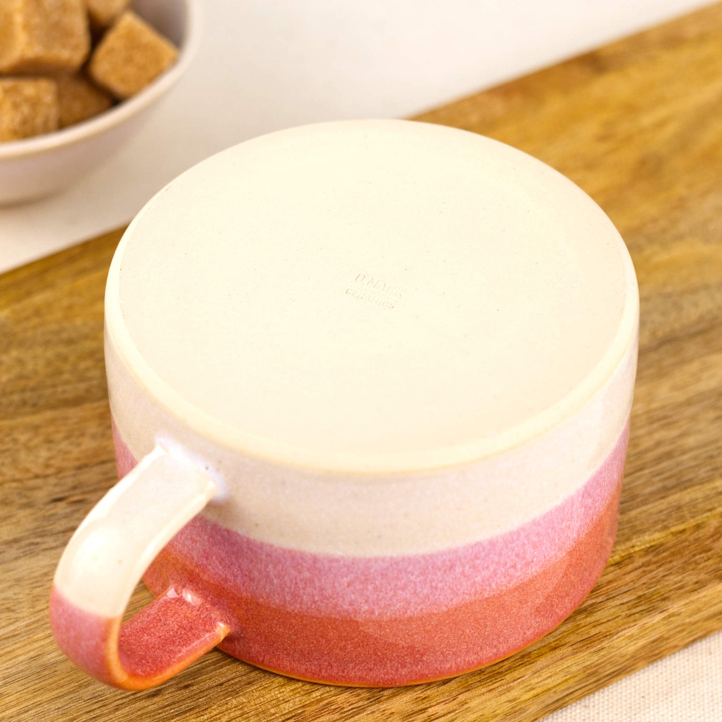 Base of handmade stoneware cappuccino cup with smooth base and maker’s mark, small studio pottery coffee mug