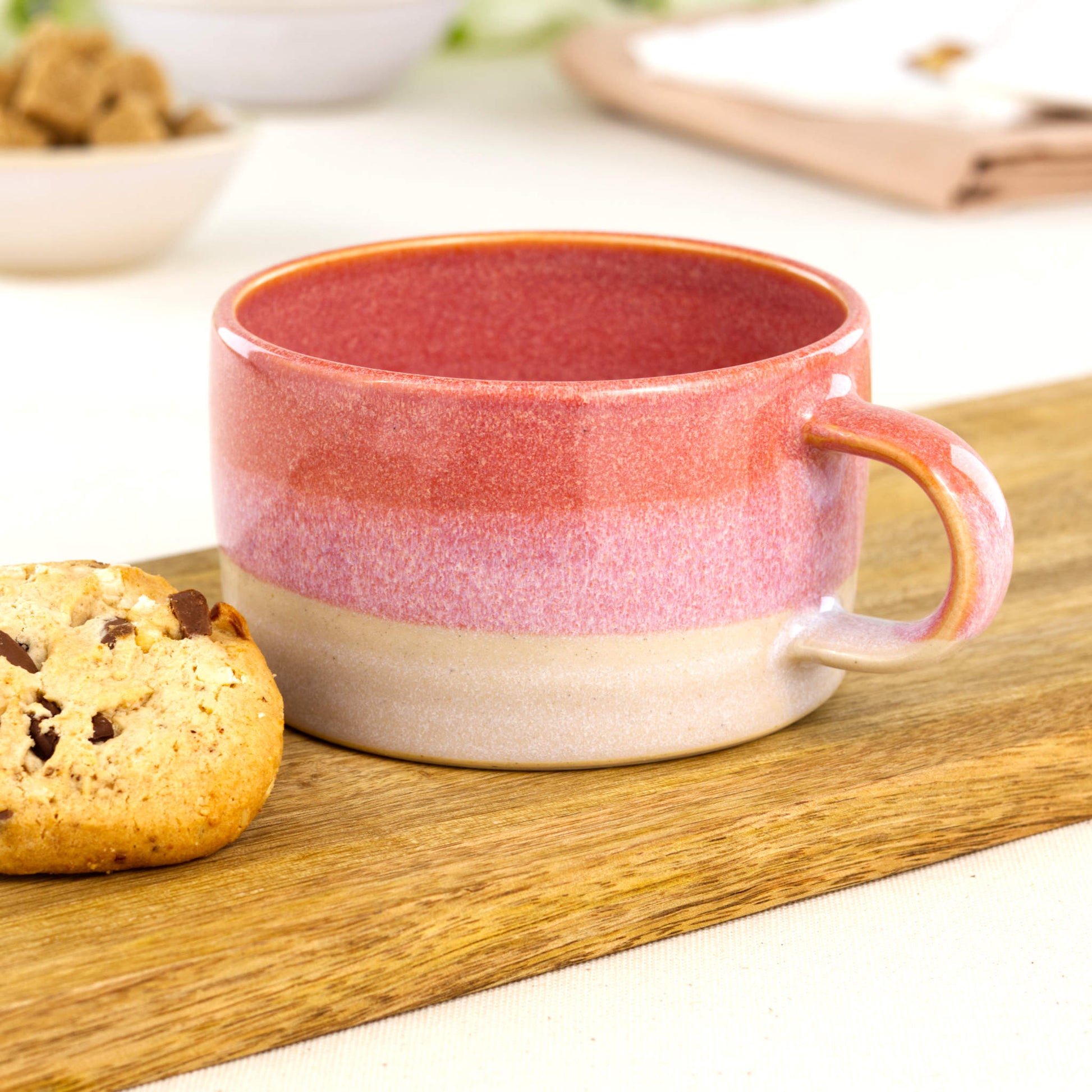 Coral and White handmade cappuccino cup on wooden board with biscuit, artisan stoneware coffee cup for weekend flat whites