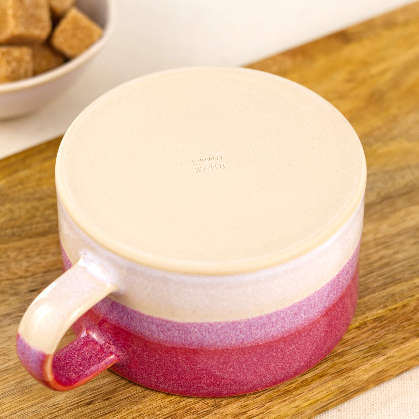 Underside of handmade stoneware cappuccino cup with smooth flat base and maker’s mark, small batch pottery mug