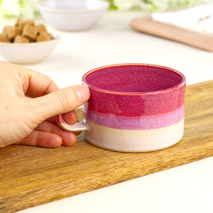Crimson and White ceramic coffee cup held in hand, wheel-thrown cappuccino mug with low wide café style profile