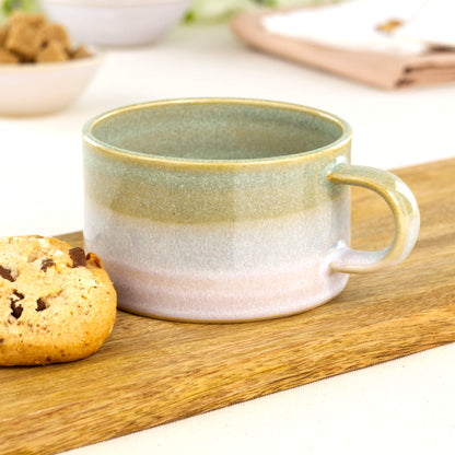 Pale Green and White handmade cappuccino mug beside biscuit on wooden board, artisan stoneware cup for flat whites and café coffee