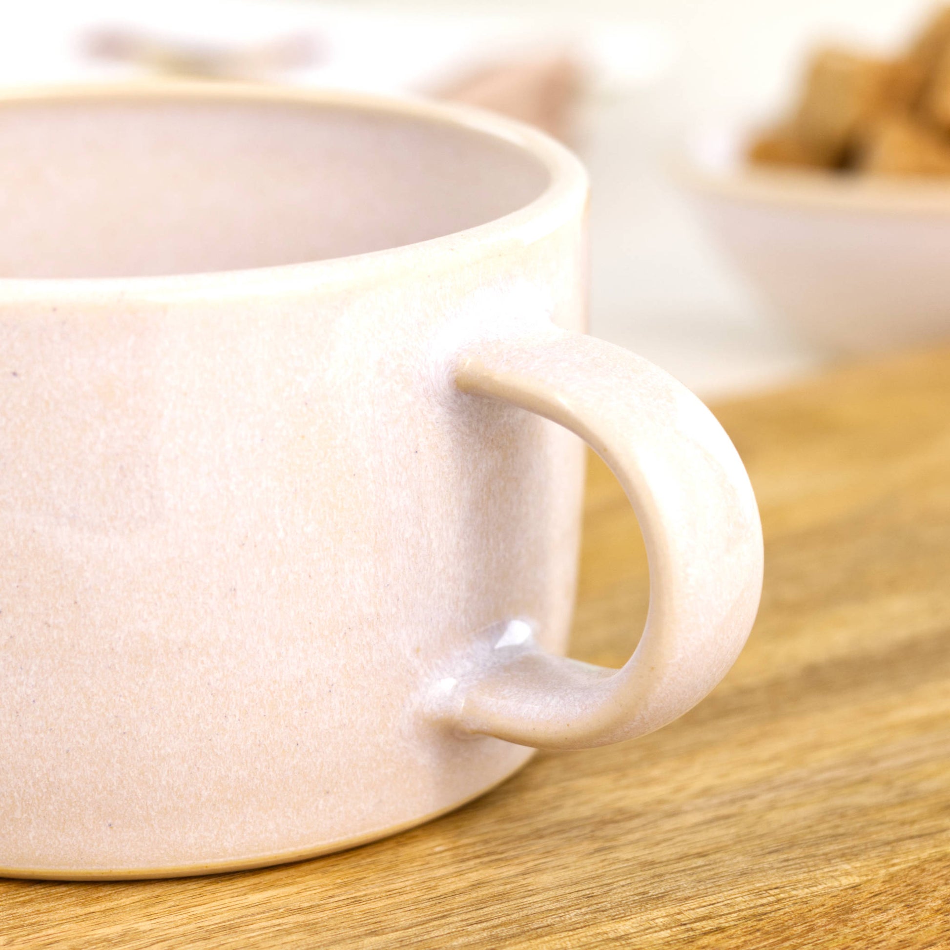 Close detail of white Sea Smoothed Pebble glaze on handmade cappuccino mug, minimalist pottery finish for coffee lovers