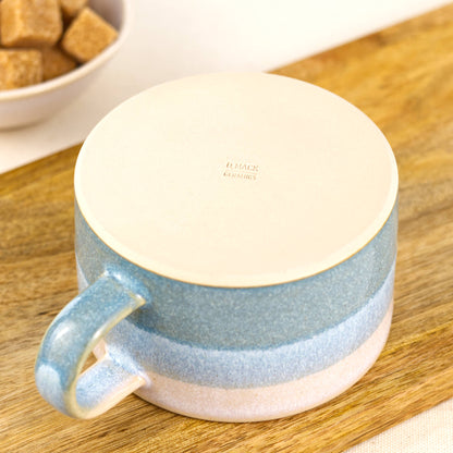 Base of handmade stoneware cappuccino cup with smooth flat underside and maker’s mark, small studio pottery coffee mug