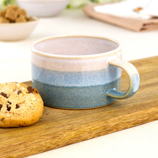 White and Coastal Blue handmade cappuccino cup on wooden board with biscuit, artisan stoneware coffee mug for flat white mornings