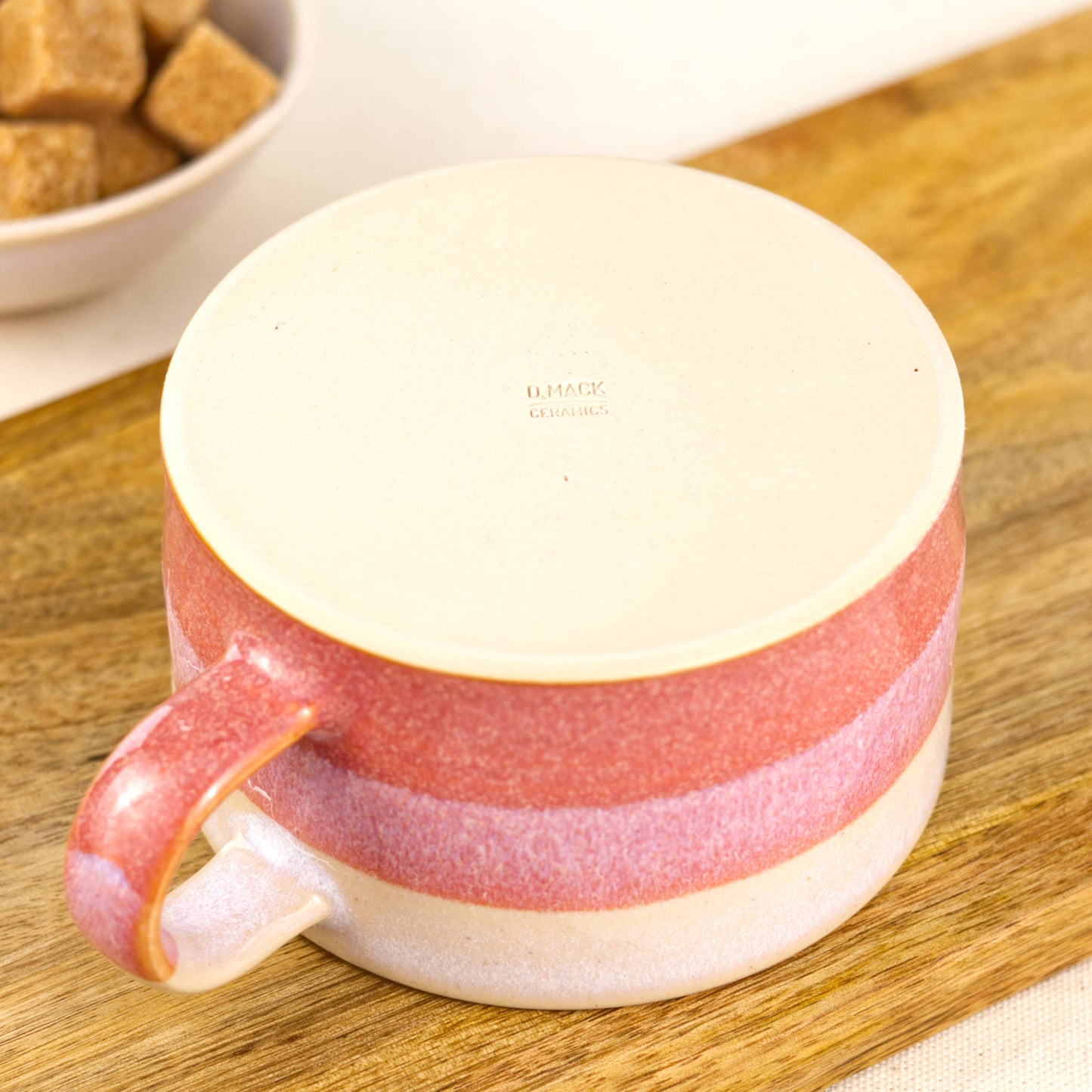 Flat underside of handcrafted cappuccino cup with maker’s mark, smooth stoneware base from Sussex pottery studio