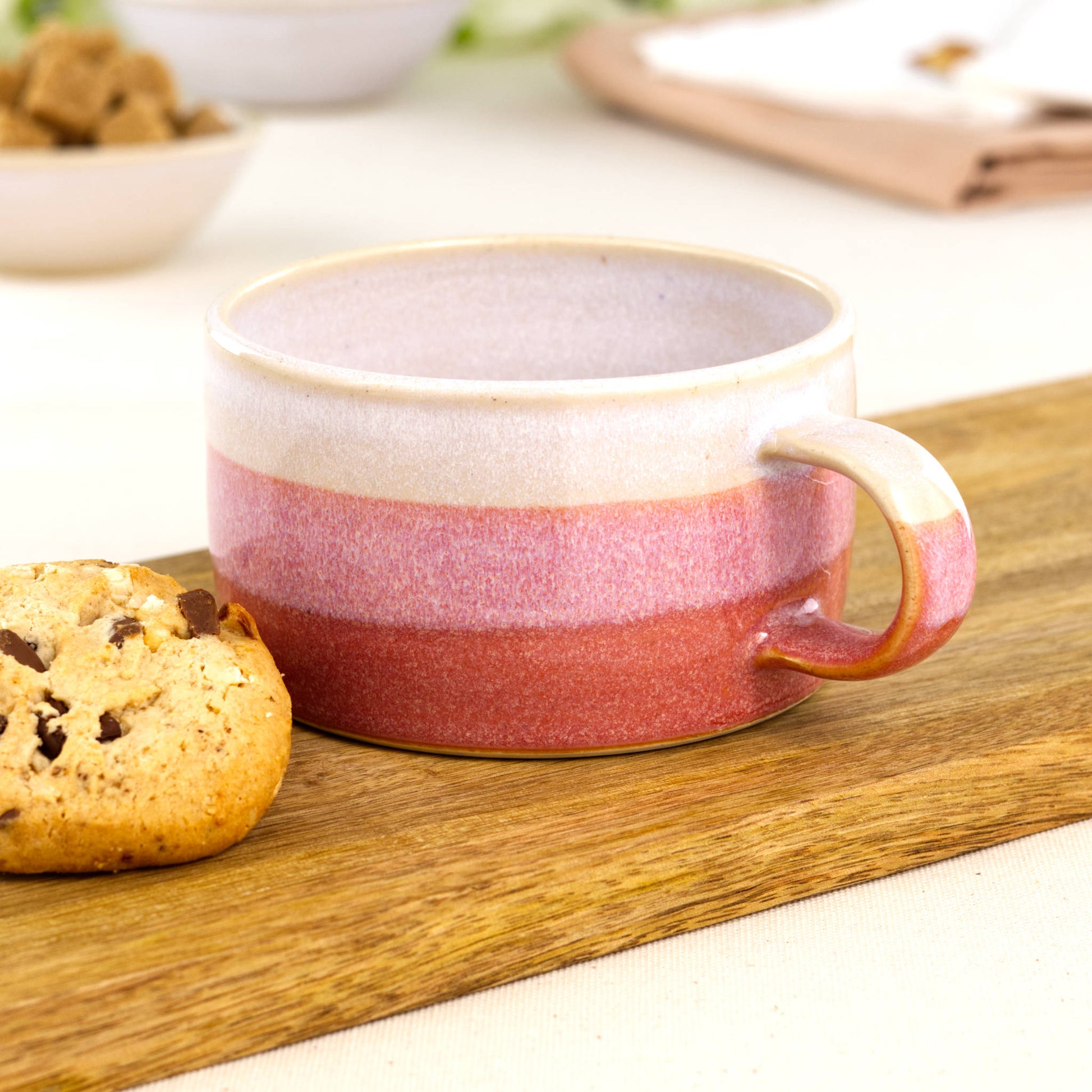 White and Coral handmade cappuccino cup beside biscuit on oak board, artisan stoneware cup for flat white coffee moments