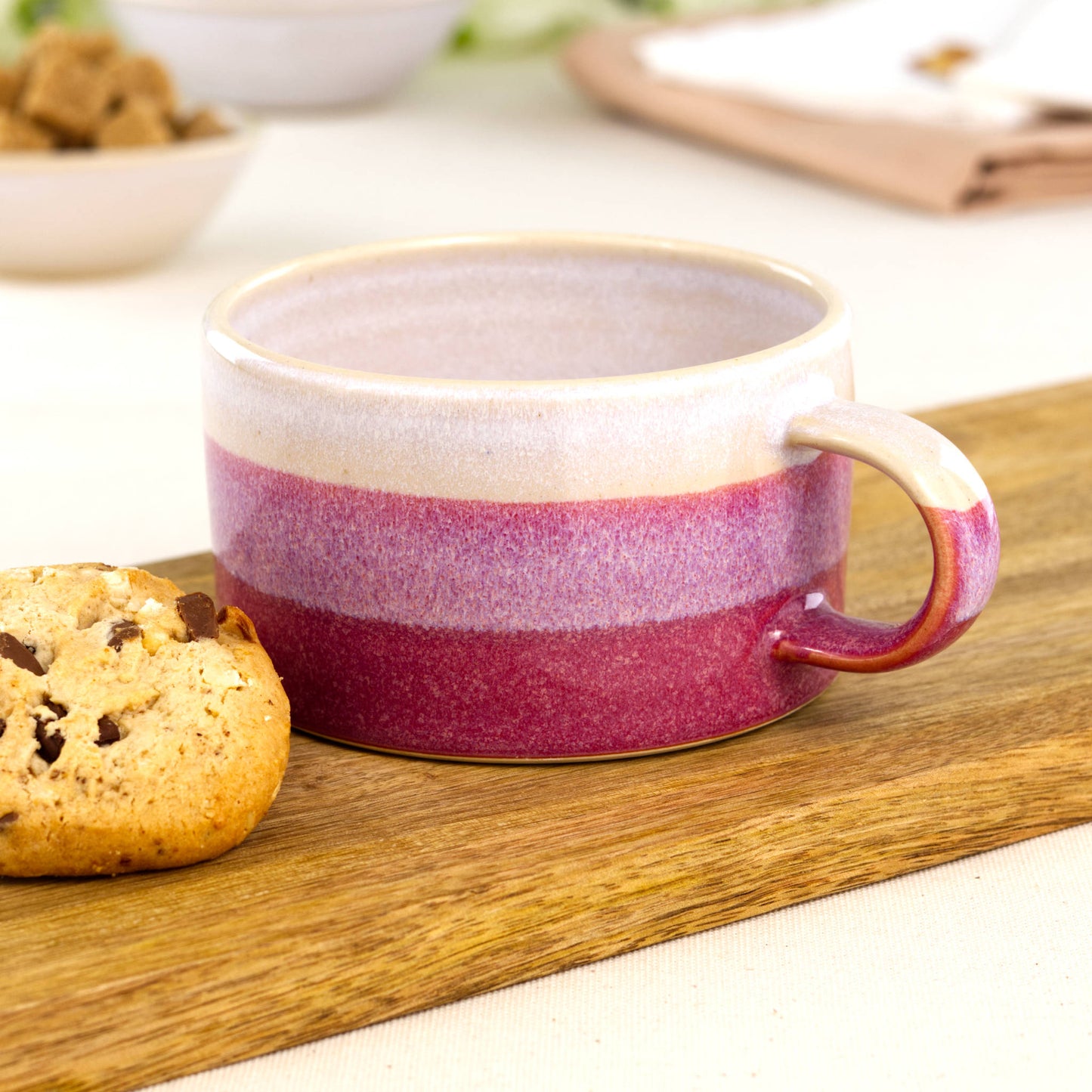 White and Crimson handmade cappuccino cup with cookie on wooden board, artisan stoneware banded coffee cup for barrista style coffees