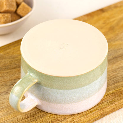 Underside of handmade stoneware cappuccino cup with smooth flat base and maker’s mark, small batch pottery mug