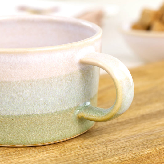 Close detail of white glaze blending into Pale Green on handcrafted cappuccino cup, glossy speckled artisan studio pottery finish