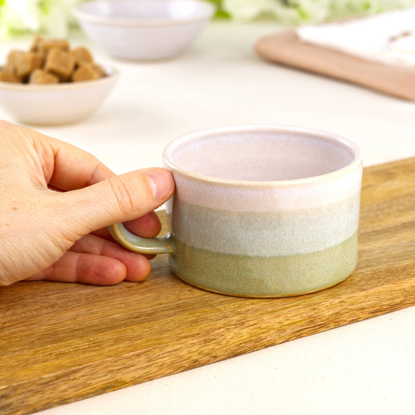 White and Pale Green ceramic coffee cup held in hand, wheel-thrown cappuccino cup with low wide coffee house style form