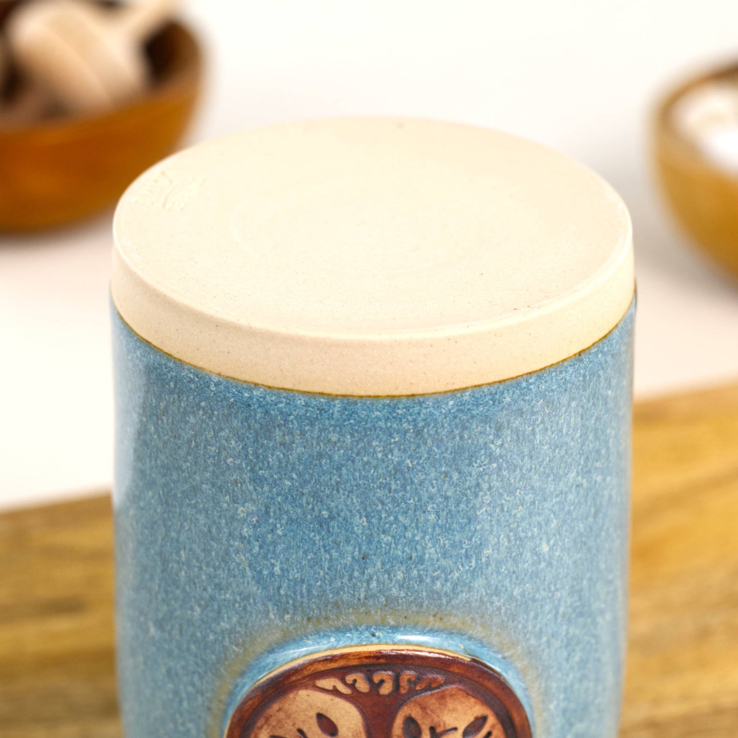 Base of handmade coastal blue refillable diffuser showing smooth stoneware foot and unglazed underside.
