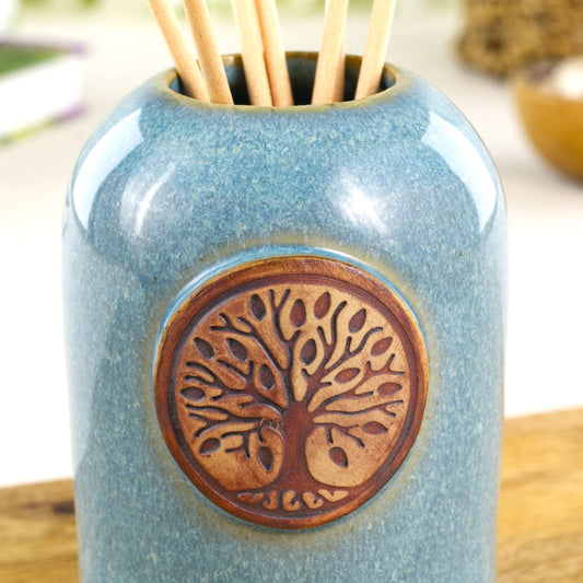 Close up of coastal blue fragrance diffuser with woodland tree of life badge and glossy speckled glaze