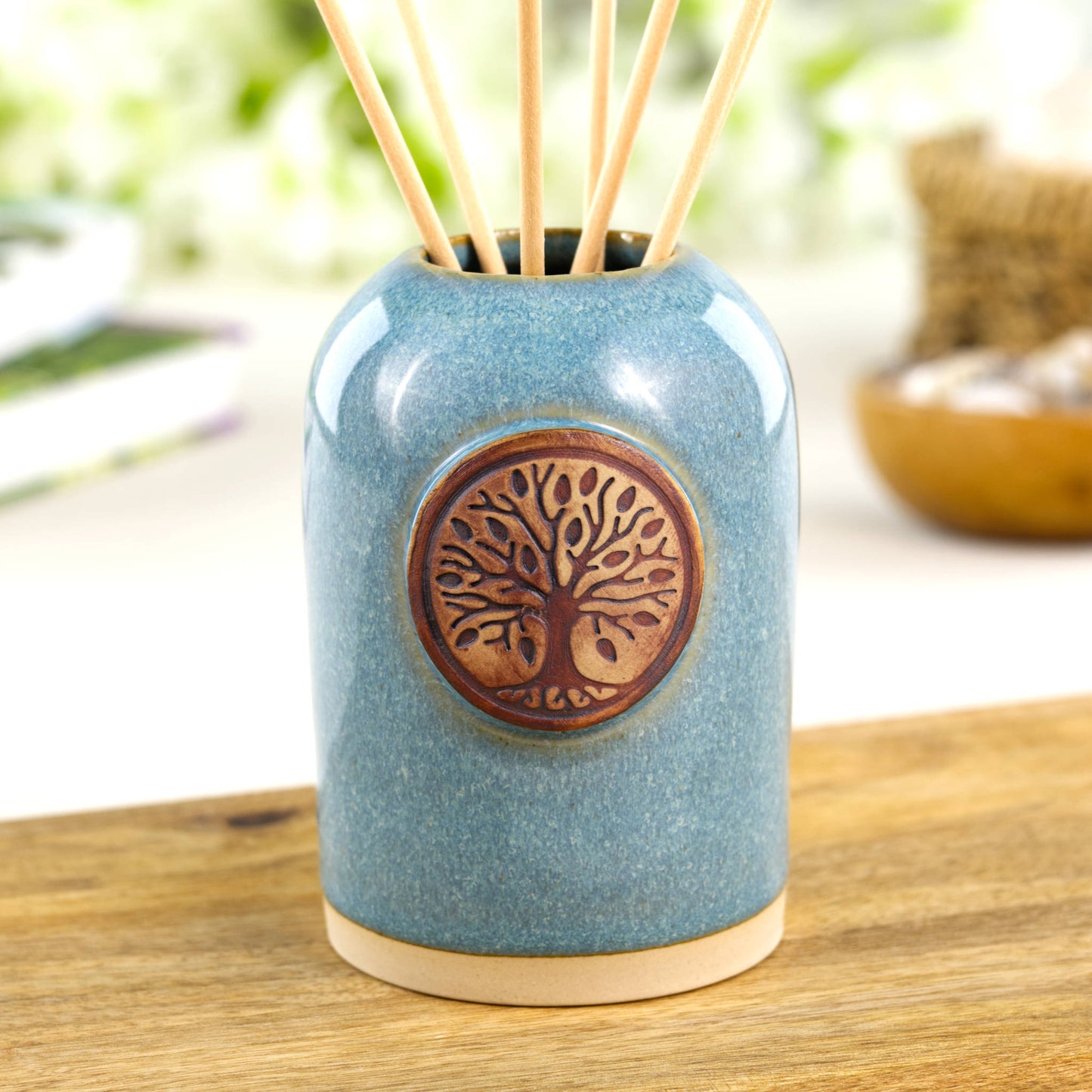 Coastal blue diffuser pot for shelf styling with decorative tree emblem and stoneware finish