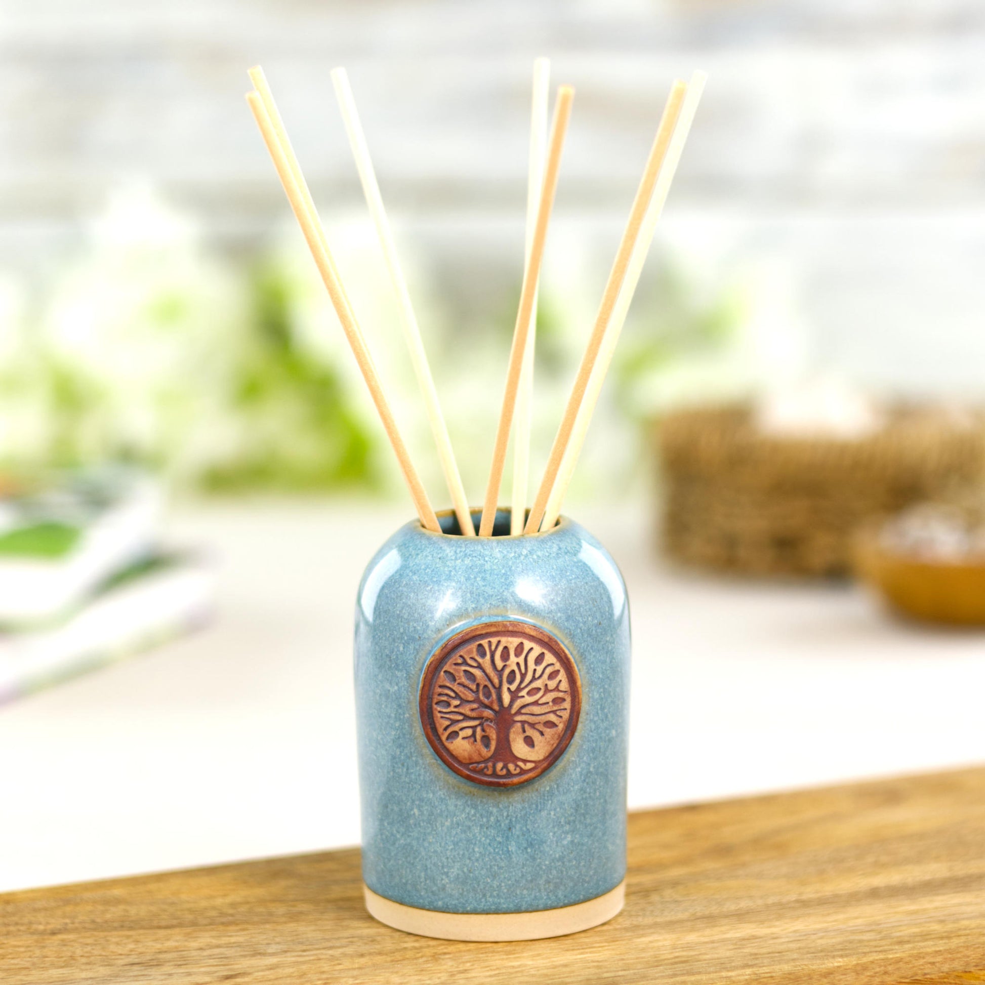 Handmade coastal blue home fragrance diffuser with natural reeds for calm bathroom decor