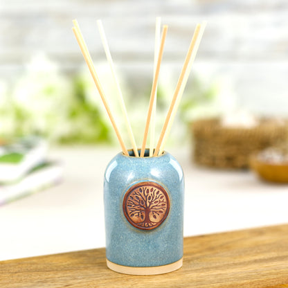 Handmade coastal blue home fragrance diffuser with natural reeds for calm bathroom decor