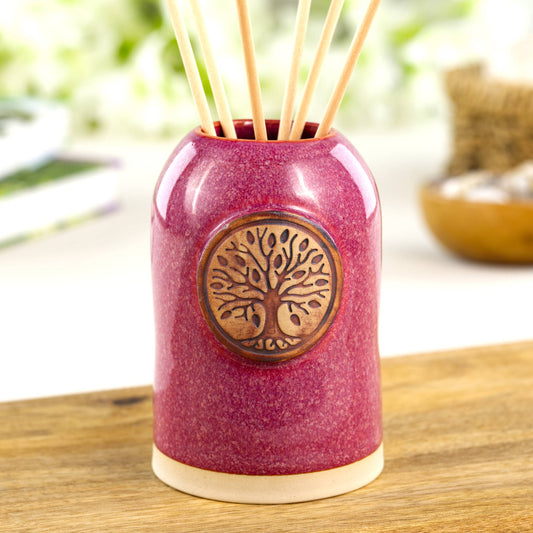 Crimson ceramic reed diffuser with rich berry glaze for cosy shelf decor or autumn home styling