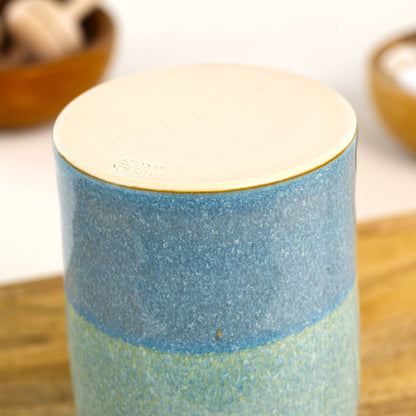 Handmade Coastal Blue and Pale Green ceramic reed diffuser with smooth burnished unglazed base, small stoneware home fragrance vessel on wooden shelf