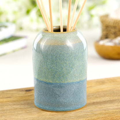 Coastal Blue and Pale Green pottery reed diffuser with rounded modern form, artisan ceramic fragrance holder for bathroom or bedside table