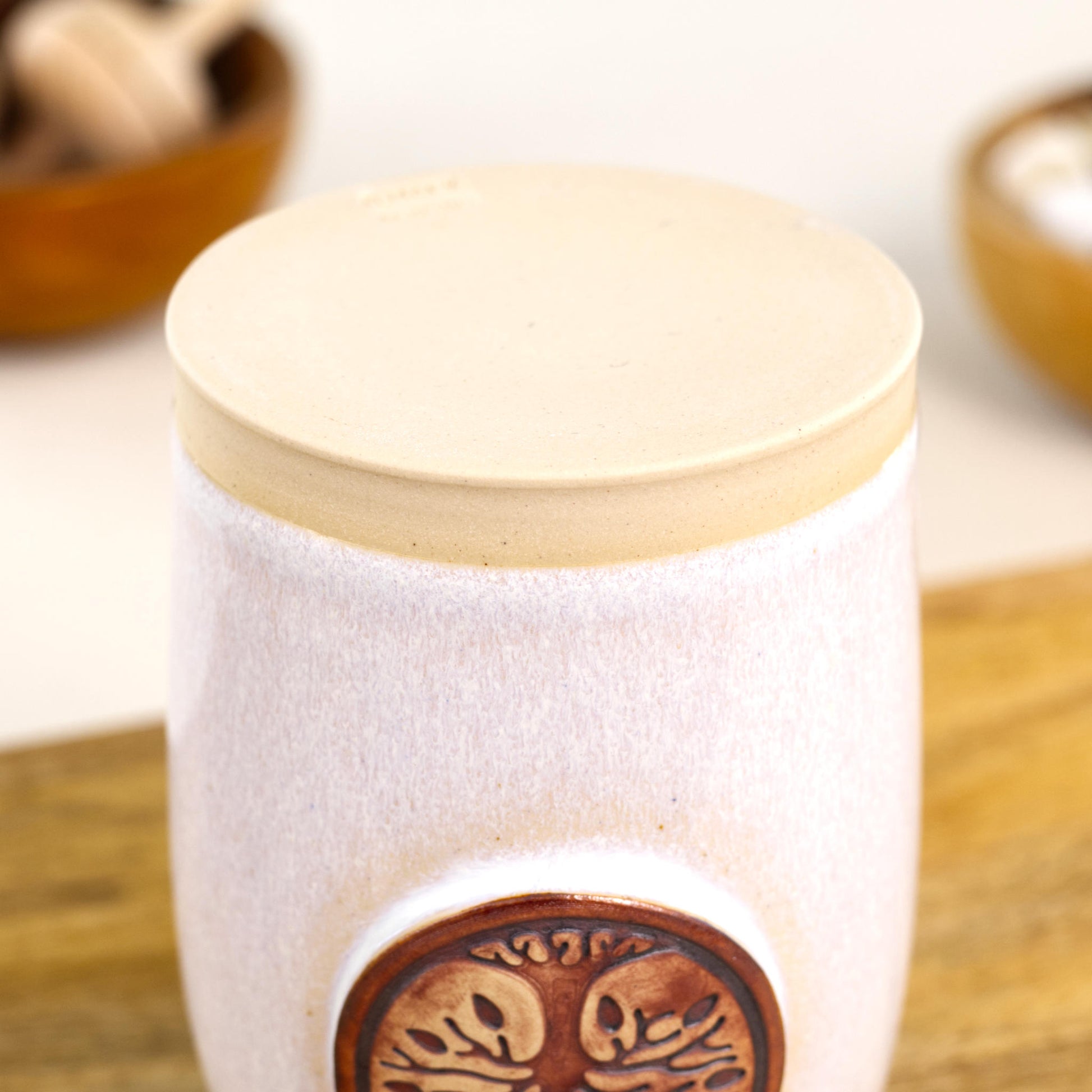 Base of handmade white ceramic diffuser with smooth unglazed stoneware foot and maker stamp
