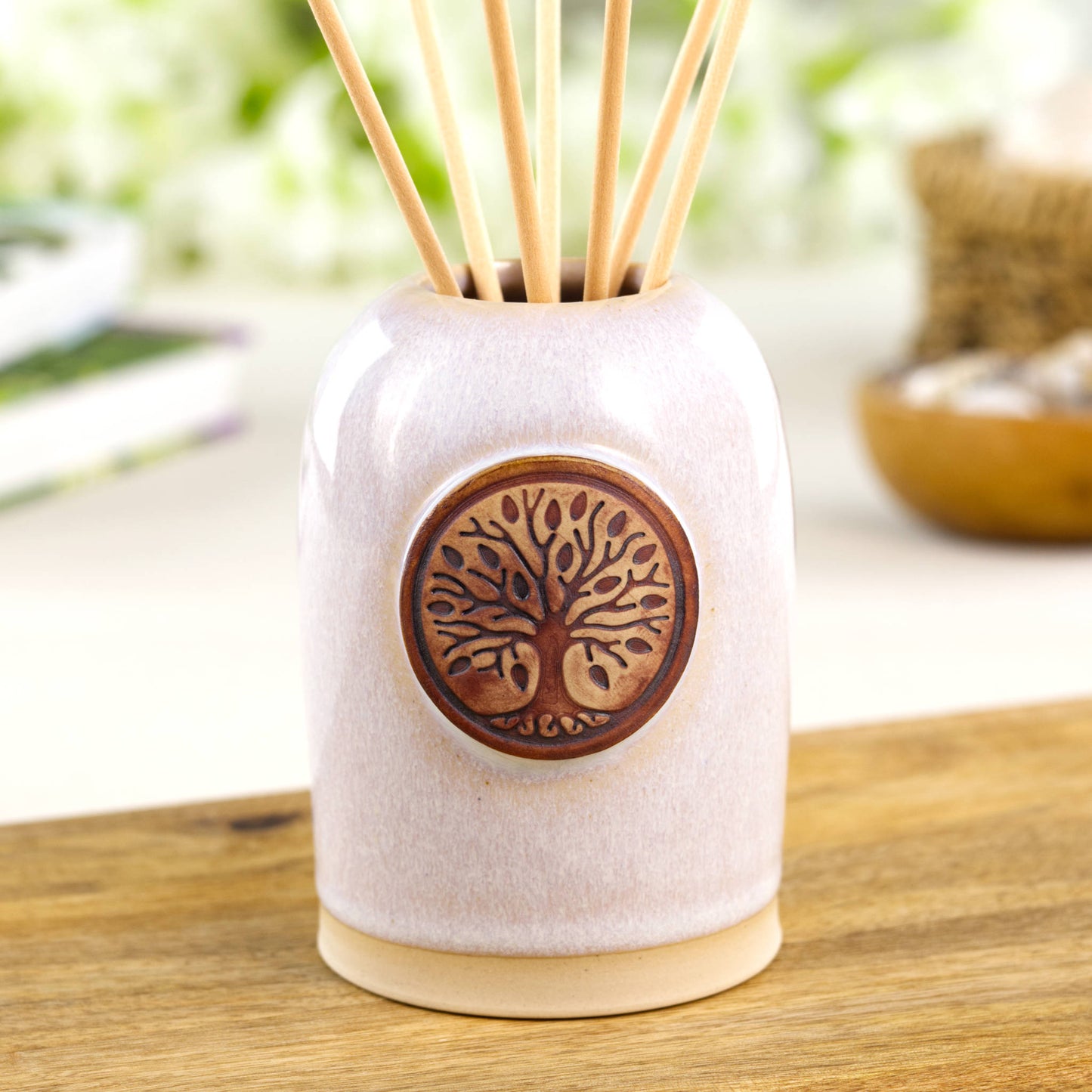 White reed diffuser in Scandinavian style ceramic vessel for calm neutral shelf decor