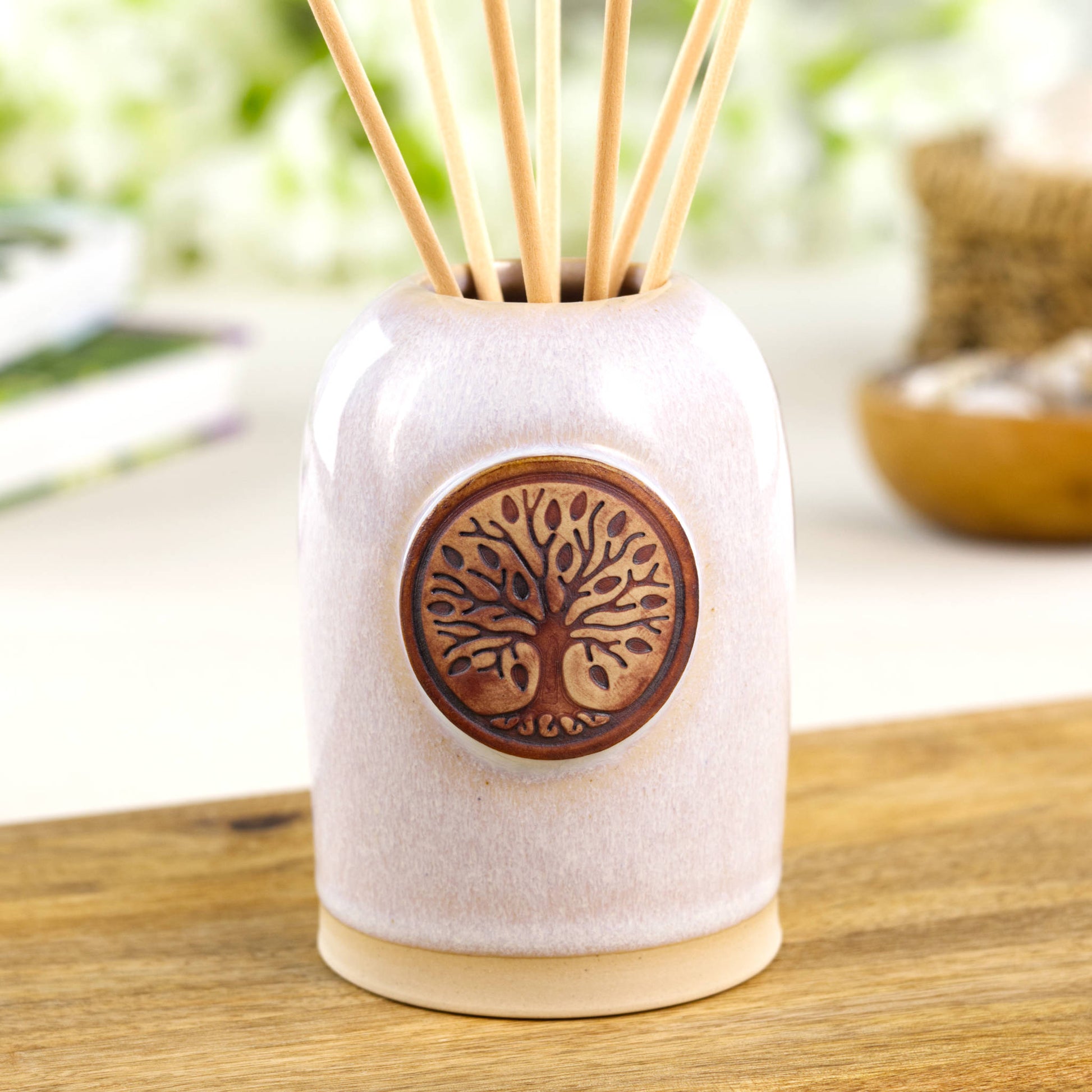 White reed diffuser in Scandinavian style ceramic vessel for calm neutral shelf decor