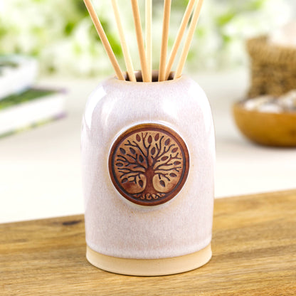 White reed diffuser in Scandinavian style ceramic vessel for calm neutral shelf decor