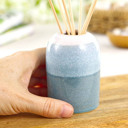 Small Coastal Blue and White handmade home fragrance pot shown in hand for size, compact pottery decor piece