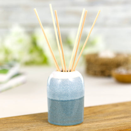 Handmade Coastal Blue and White reed diffuser with natural rattan reeds, calm spa bathroom decor accessory
