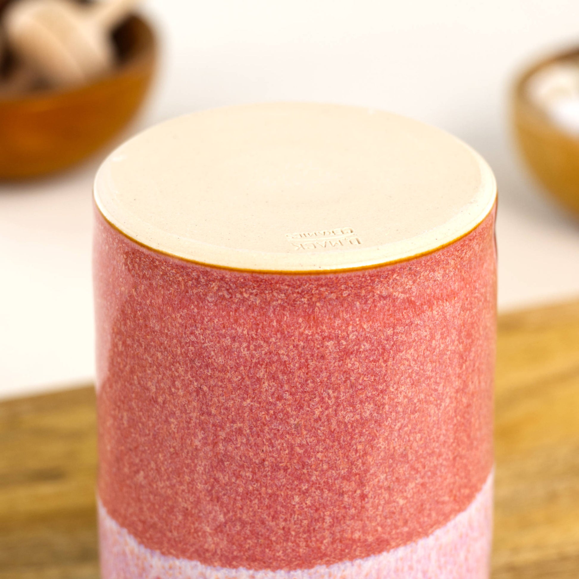 Handmade stoneware diffuser vessel base in Coral and White with smooth unglazed underside and maker’s mark