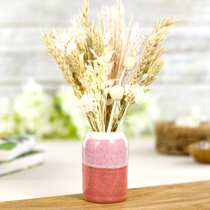 Coral and White reed diffuser vessel styled as a small vase with dried flowers and natural stems