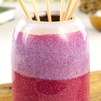 Wheel-thrown stoneware reed diffuser in crimson and white with glossy speckled glaze, layered colour band and rounded neck detail