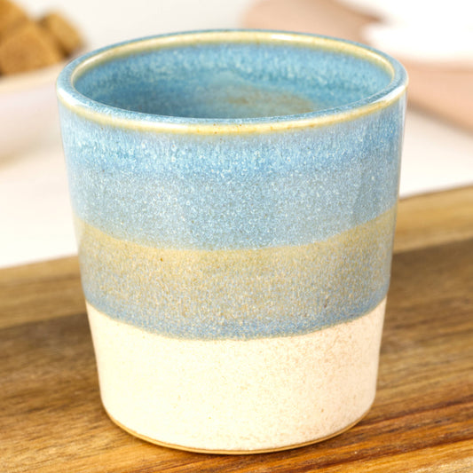 Handmade banded espresso cup close-up showing Sea Smoothed Pebble glaze and satin matte sandy base